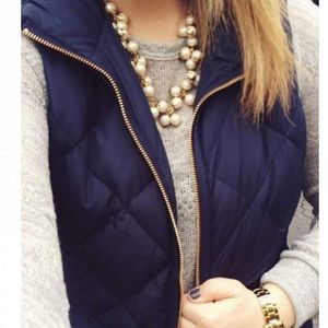 Navy quilted vest with gold accents
